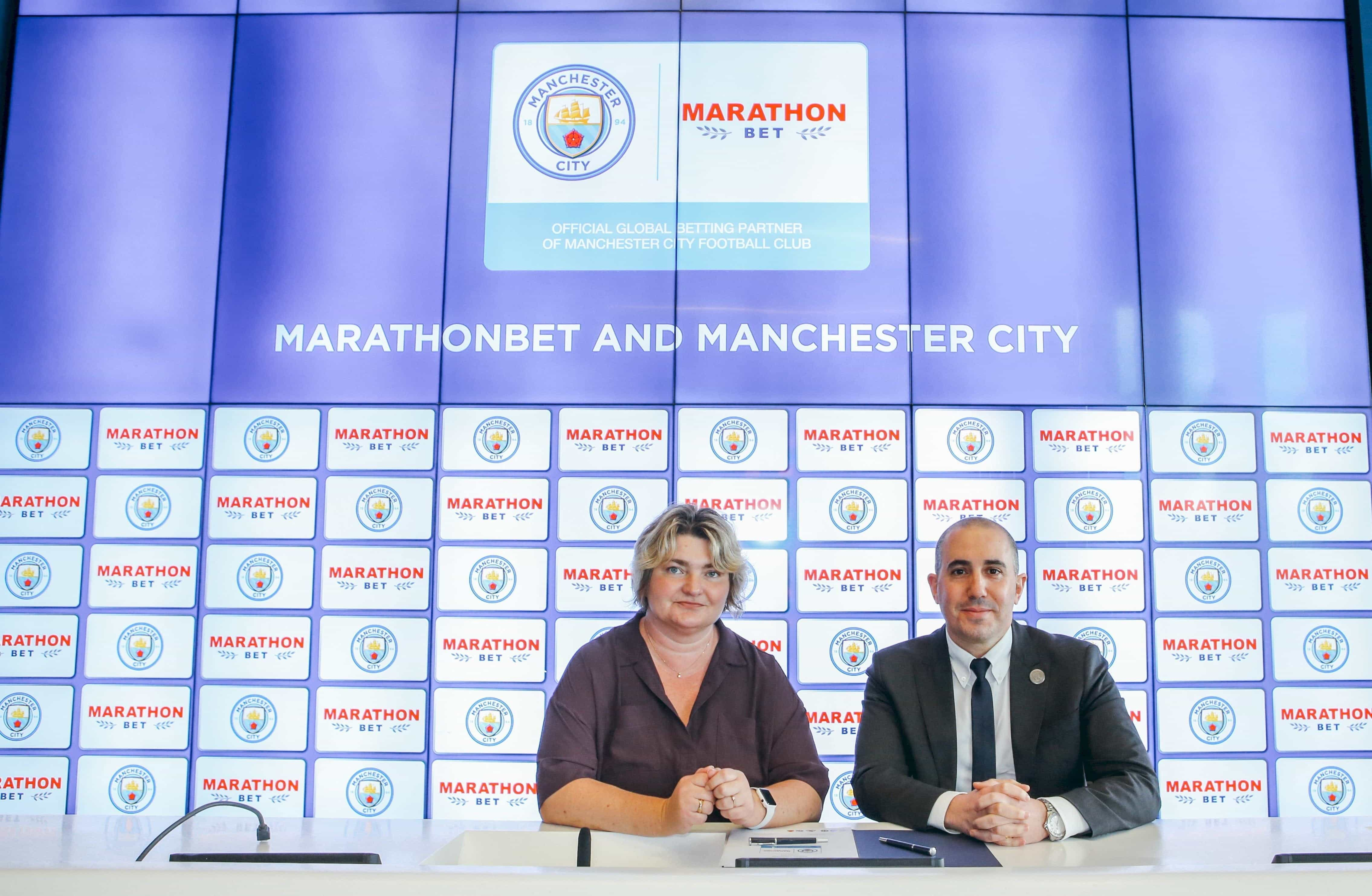 Damian Willoughby and , Natalia Zavodnik signing an agreement between Marathonbet and Manchester CIty.