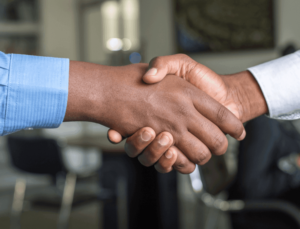 Two businessmen shake hands in a deal.