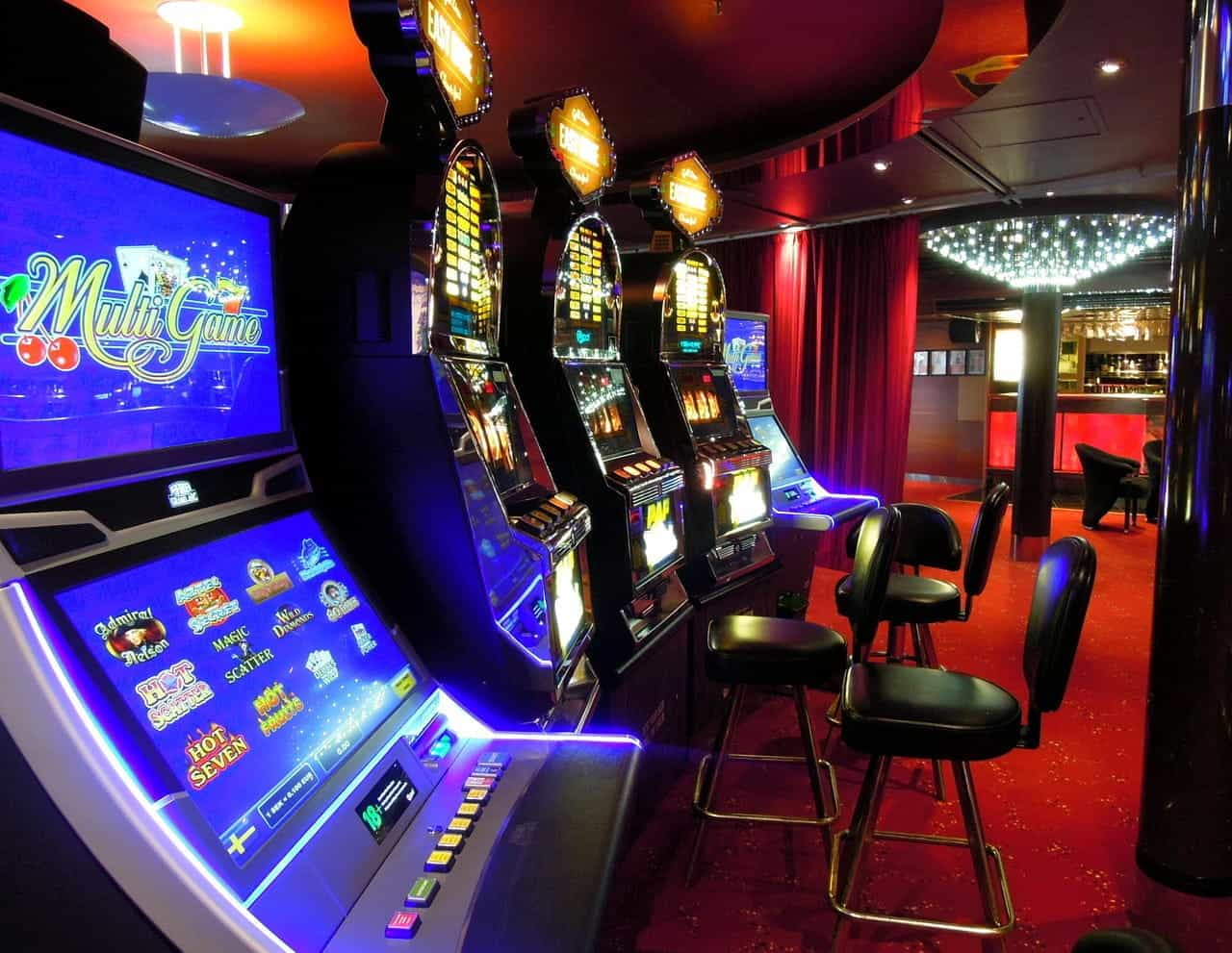 A view of several slot machines in a dimly lit casino.