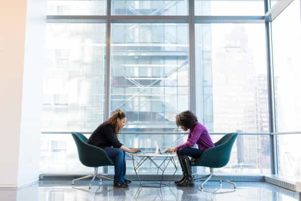 Two women working in a modern office building.