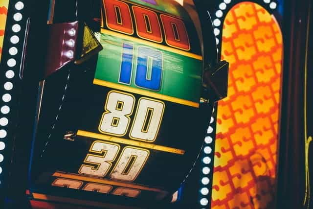 A brightly-lit roulette wheel in a casino.