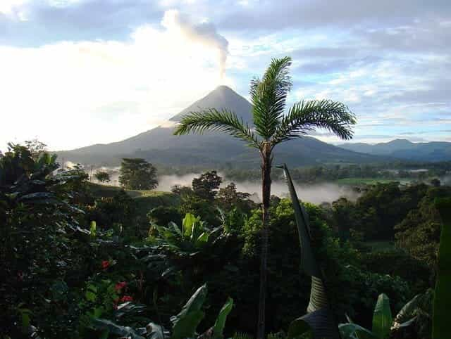 A volcano erupts over the jungle in Costa Rica.