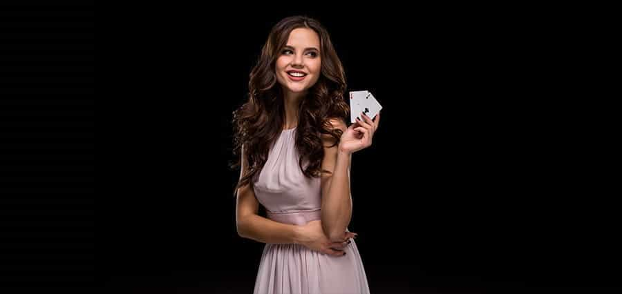 A woman holding playing cards.