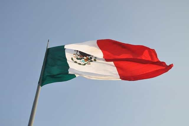 Mexico’s flag flies on a flagpole.