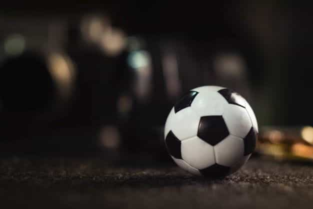 A lone soccer ball rolls against an indistinct background.