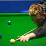 Snooker pro Kyren Wilson taking a shot.