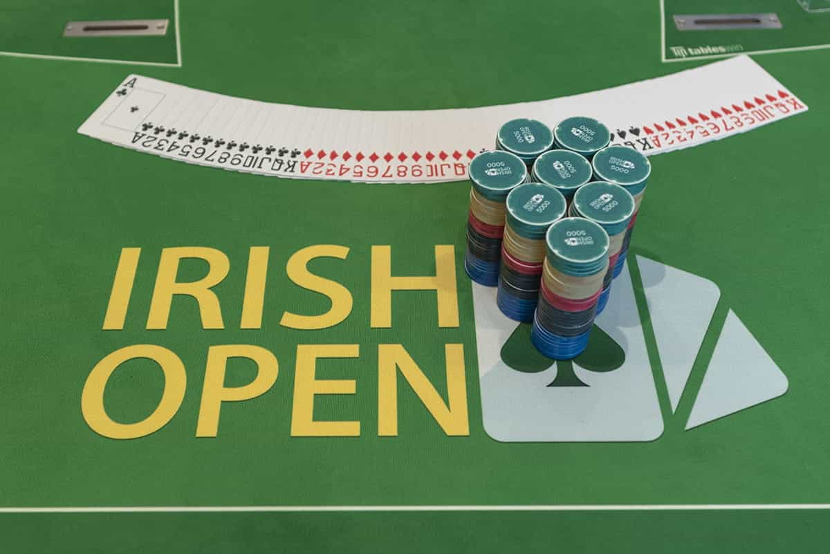 Cards and chips neatly prepared on an Irish Poker Open table.