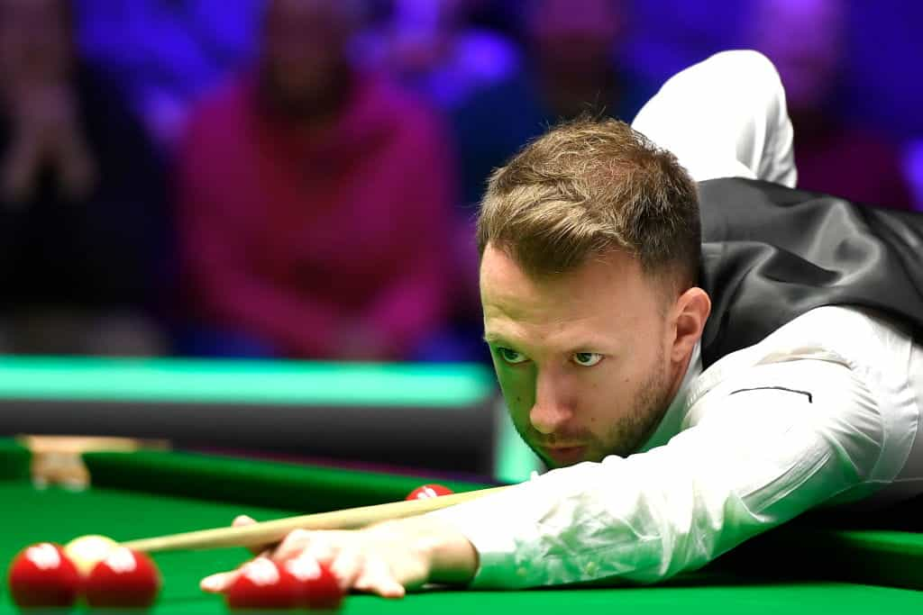 Judd Trump concentrating as he takes a shot.