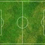 An overhead view of a football pitch markings in white on grass.