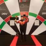 Winner Michael Smith poses with his Bahrain Darts Masters trophy.