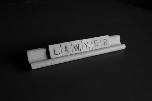 Scrabble letters spell out the word LAWYER.