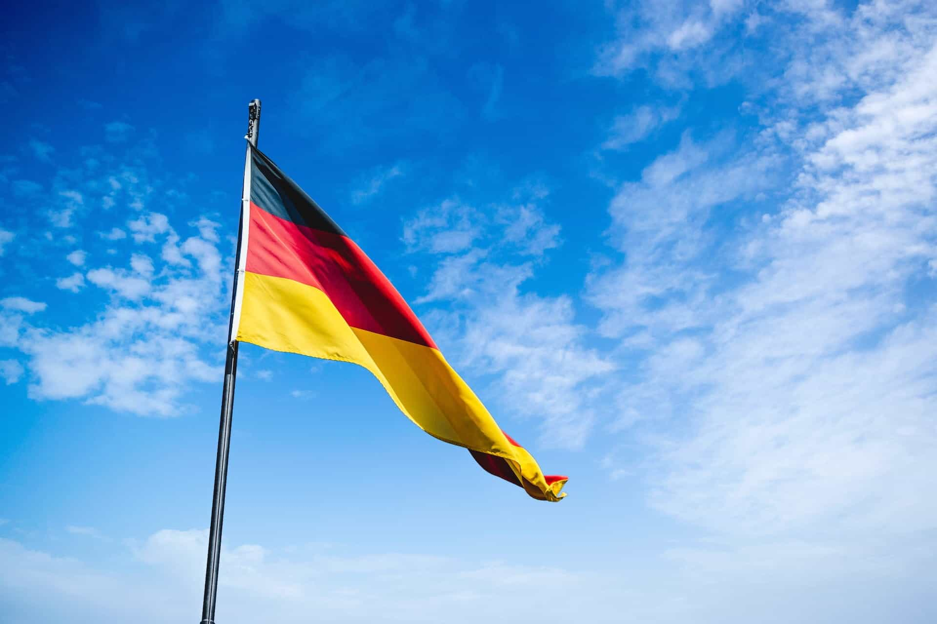 German flag against blue sky.