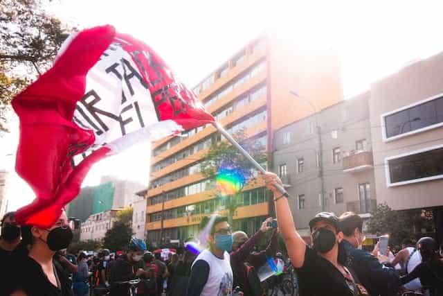 Peruvians wave their flag during a protest.