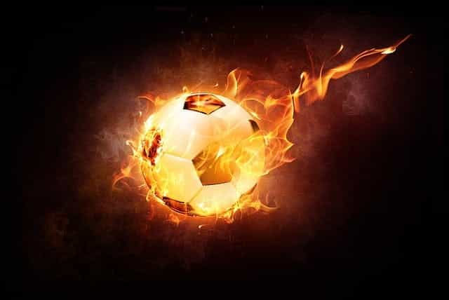 A soccer ball flying through the air while on fire.