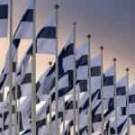 Multiple Finnish flags fluttering.