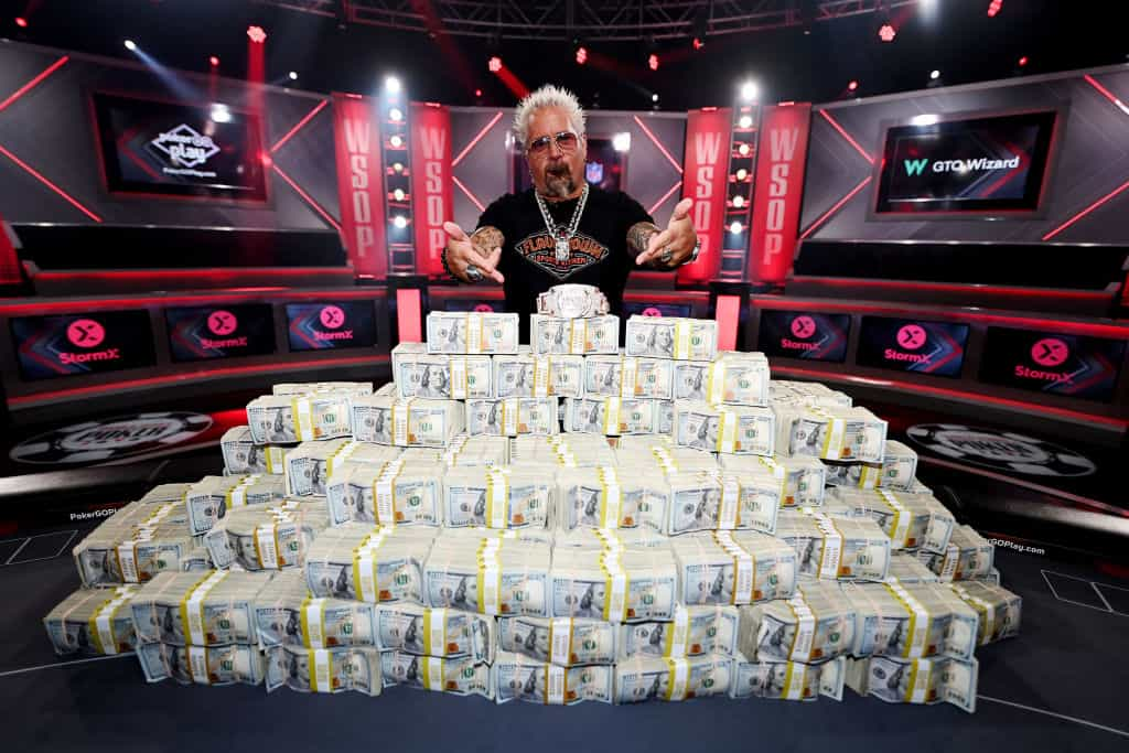 Guy Fieri Poses with the 2023 World Series Of Poker Main Event Bracelet and a Stack of Cash at Horseshoe Las Vegas.