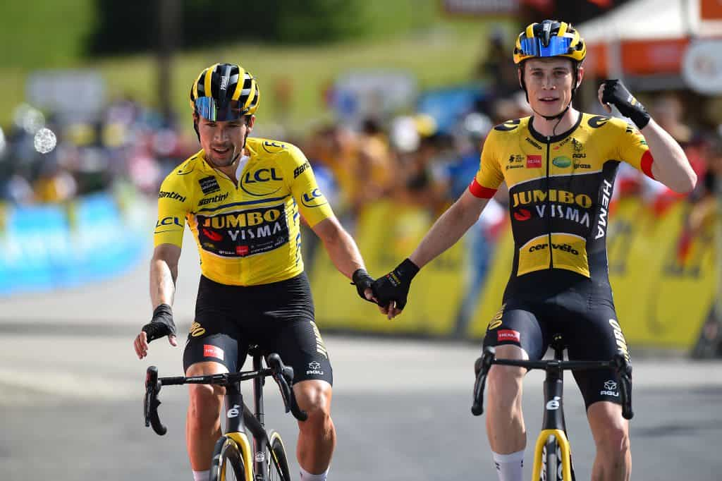 Primoz Roglic and Jonas Vingegaard of Team Jumbo-Visma hold hands crossing the winning line.