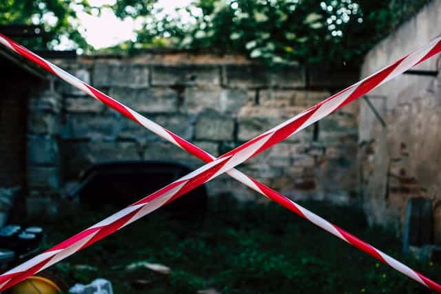 White and red tape block a courtyard.