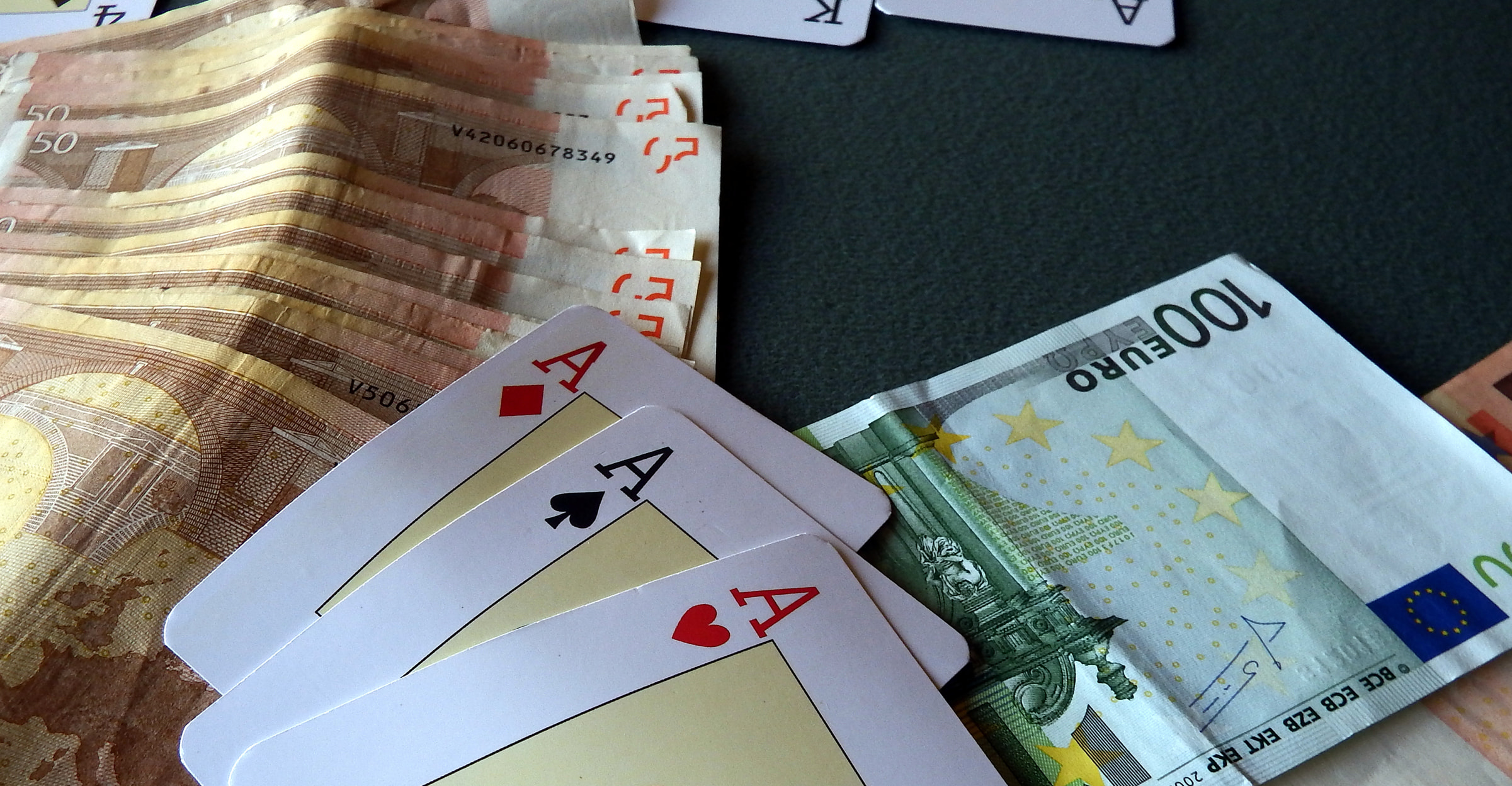 Three Aces sat along cash Euro notes.